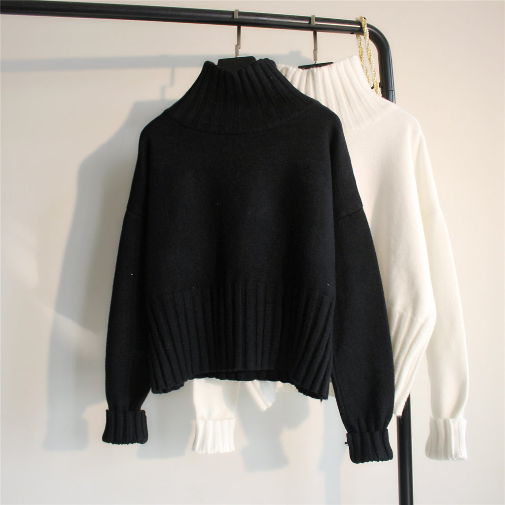 Black ribbed turtleneck knit sweater with balloon sleeves and ribbed hem