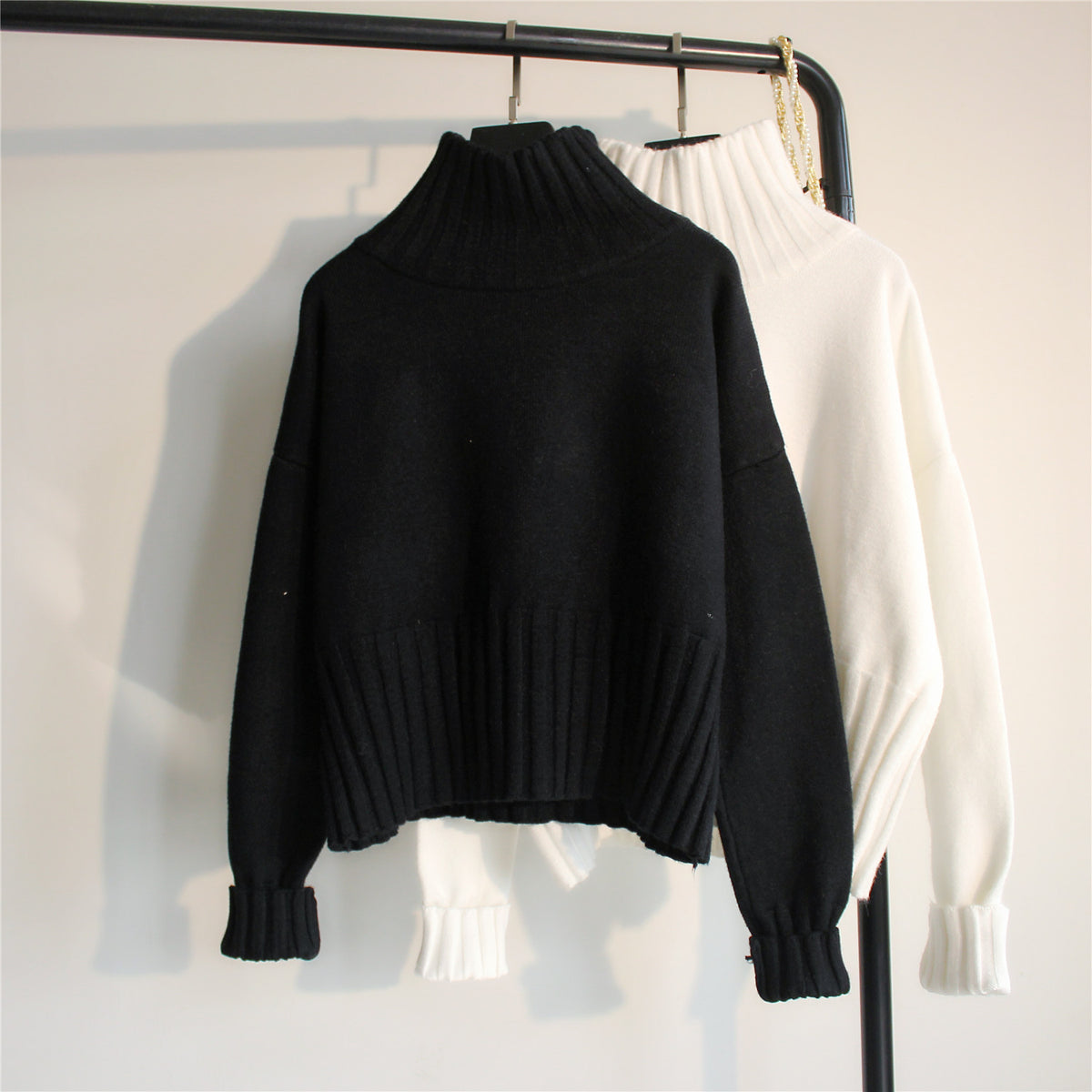 Black ribbed turtleneck knit sweater with balloon sleeves and ribbed hem