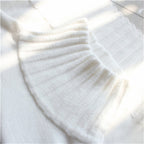 White ribbed turtleneck sweater neckline with vertical knit texture