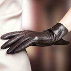 Women’s dark brown leather gloves with whipstitch trim and vented cuff