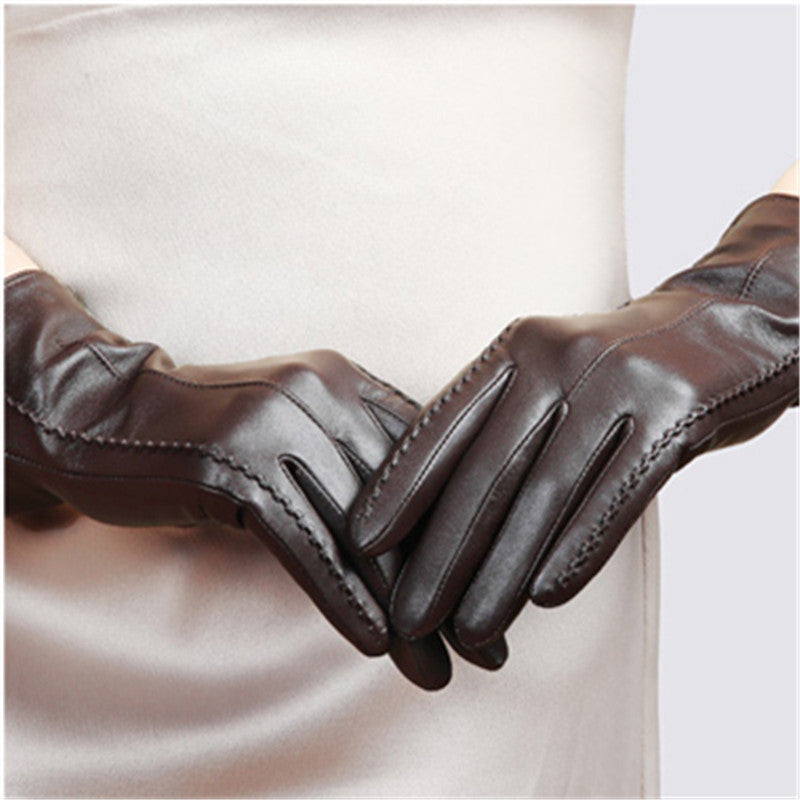 Women’s dark brown leather gloves with decorative whipstitch seams and vented cuff