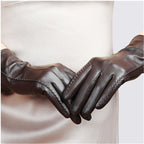 Women’s dark brown leather gloves with decorative whipstitch seams and vented cuff