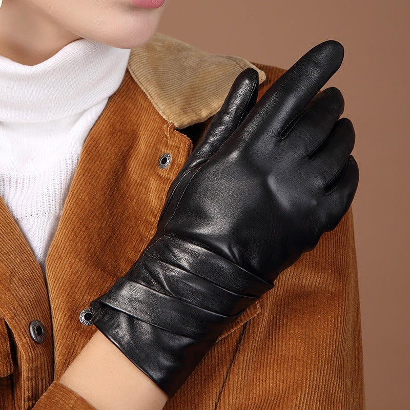 Black leather women’s glove with pleated strap detail across the back