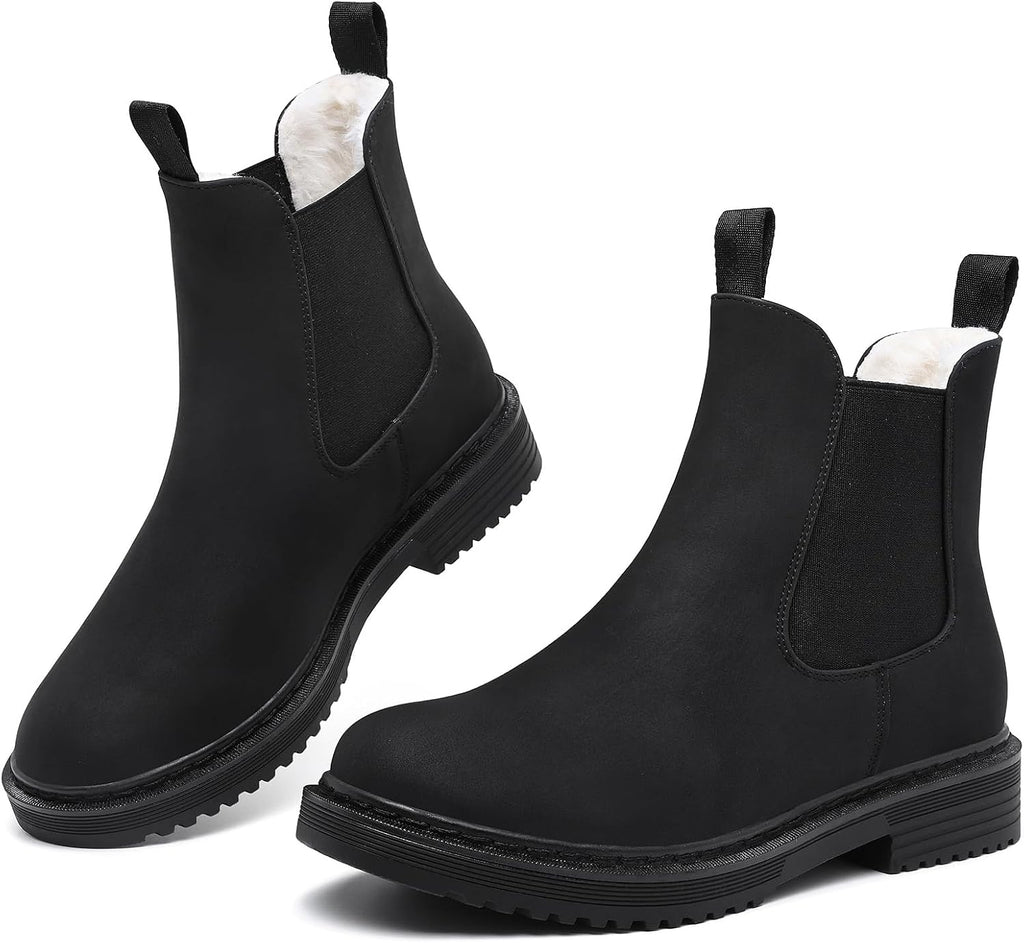 Matte black faux fur lined Chelsea ankle boots with elastic gussets and lug soles