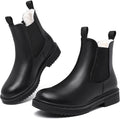 Black faux fur lined Chelsea ankle boots with elastic gussets, pull tabs, and lug soles
