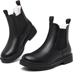 Black faux fur lined Chelsea ankle boots with elastic gussets, pull tabs, and lug soles