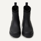 Pair of black Chelsea ankle rain boots with elastic side panels and rounded toe
