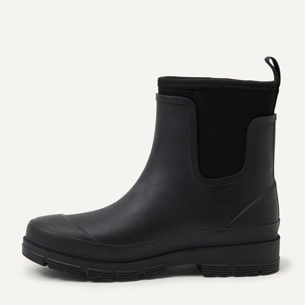 Black Chelsea ankle rain boot with pull tab, elastic gore, and lug tread sole
