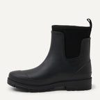 Black Chelsea ankle rain boot with pull tab, elastic gore, and lug tread sole
