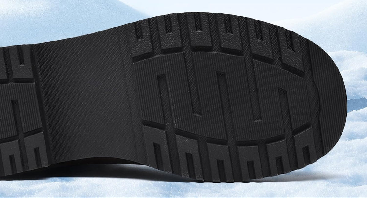 Close-up of a black boot outsole showing its deep geometric tread
