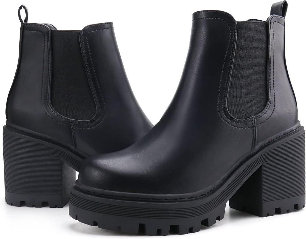 Pair of black faux leather Chelsea ankle boots with elastic panels and lug soles