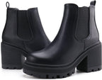 Pair of black faux leather Chelsea ankle boots with elastic panels and lug soles