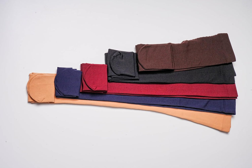 Assorted fleece-lined opaque tights in multiple colors, neatly folded stack.