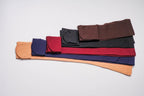 Assorted fleece-lined opaque tights in multiple colors, neatly folded stack.
