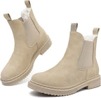 Beige faux fur lined Chelsea ankle boots with elastic gussets, pull tabs, and lug soles