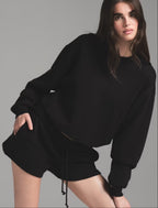 Black oversized crew neck sweatshirt with matching drawstring lounge shorts set.