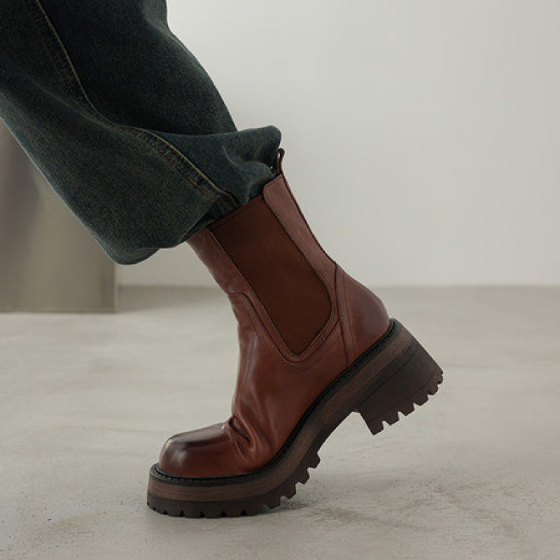 Brown leather Chelsea boots with elastic side panels and chunky tread sole, round toe