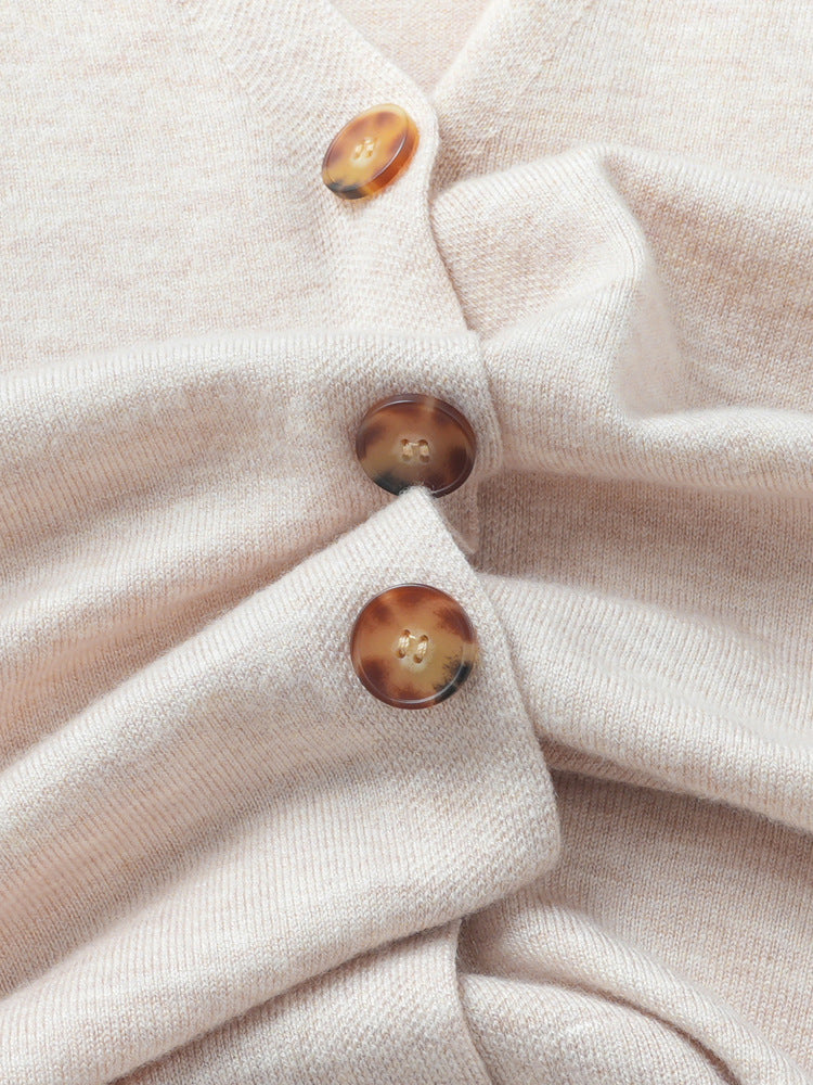 Cream knit cardigan fabric and three buttons on front placket
