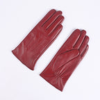 Women's red leather winter gloves pair, fleece-lined, three-panel stitched design