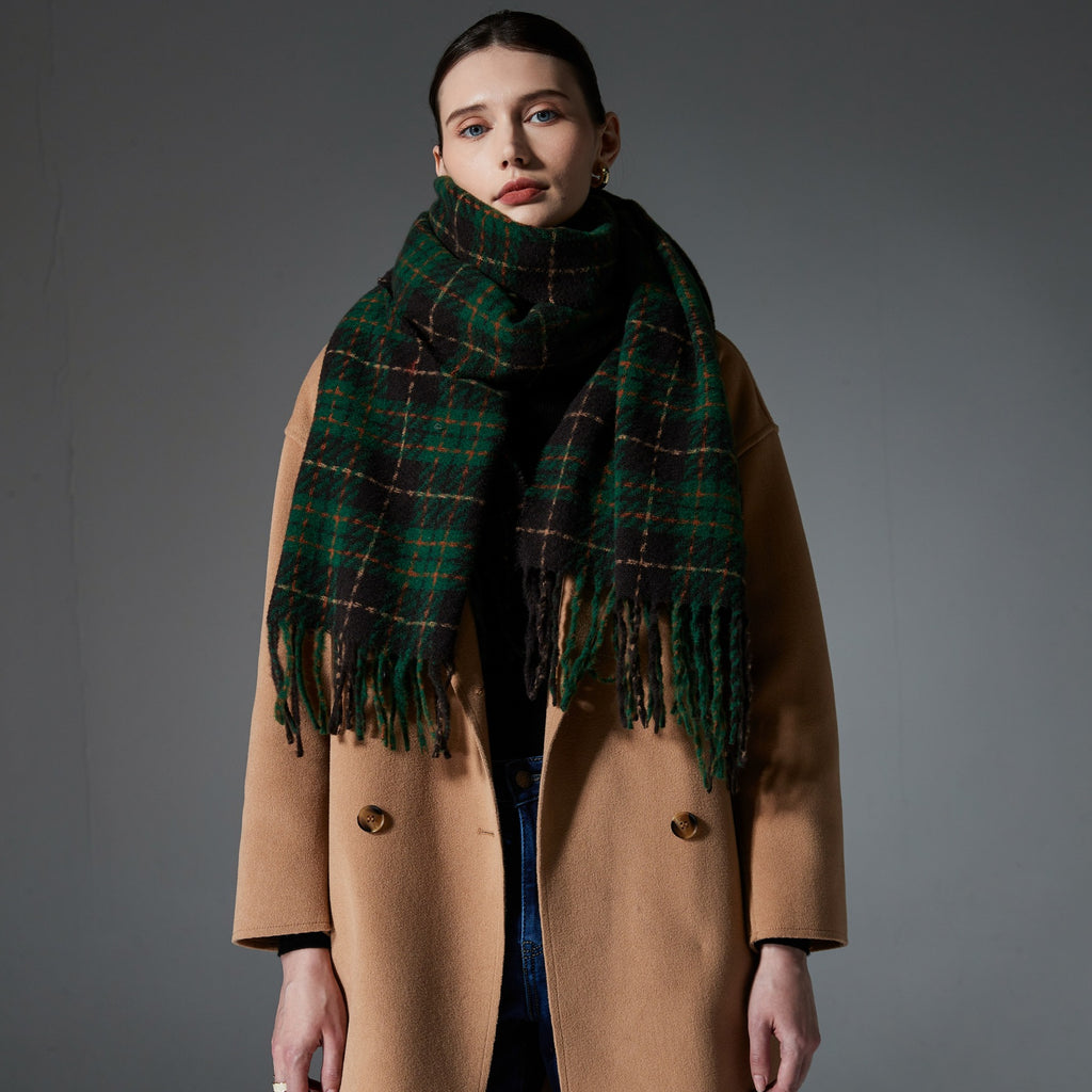 Green plaid scarf with fringed ends, draped around shoulders