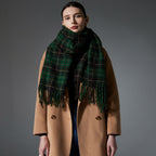 Green plaid scarf with fringed ends, draped around shoulders