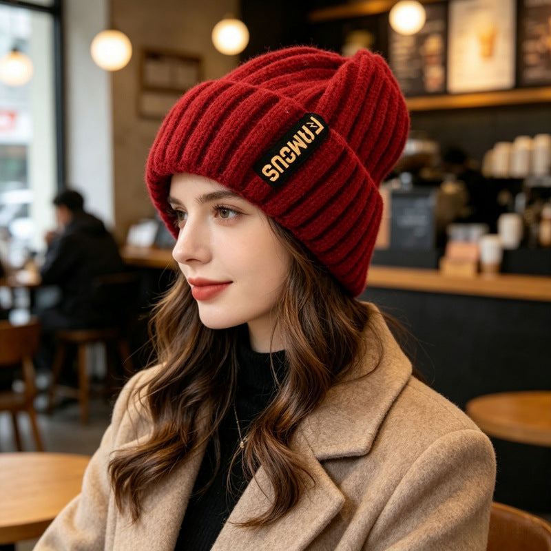 Chunky ribbed beanie in dark red with folded cuff and letter patch