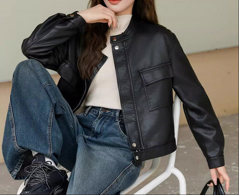 Cropped black faux leather jacket with stand collar, zip front, chest flap pocket detail
