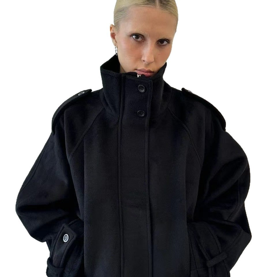 Black cropped wool jacket, close-up front, funnel neck, button front, epaulettes.