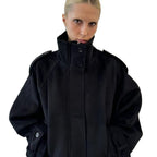 Black cropped wool jacket, close-up front, funnel neck, button front, epaulettes.