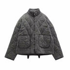 Gray quilted stand-collar zip-up jacket with long sleeves and two flap chest pockets.
