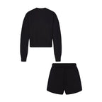 Black crew neck sweatshirt and matching drawstring shorts, two-piece lounge set.