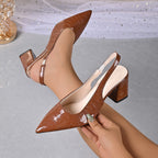 Brown croc-embossed slingback pumps with pointed toe and block heel.