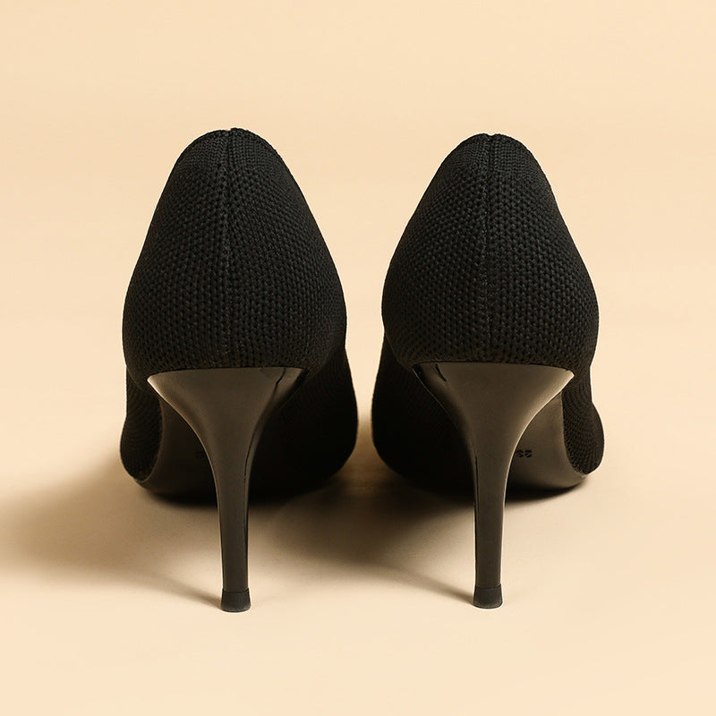 Pair of women's pointed-toe knit stiletto pumps, black, rear heel view