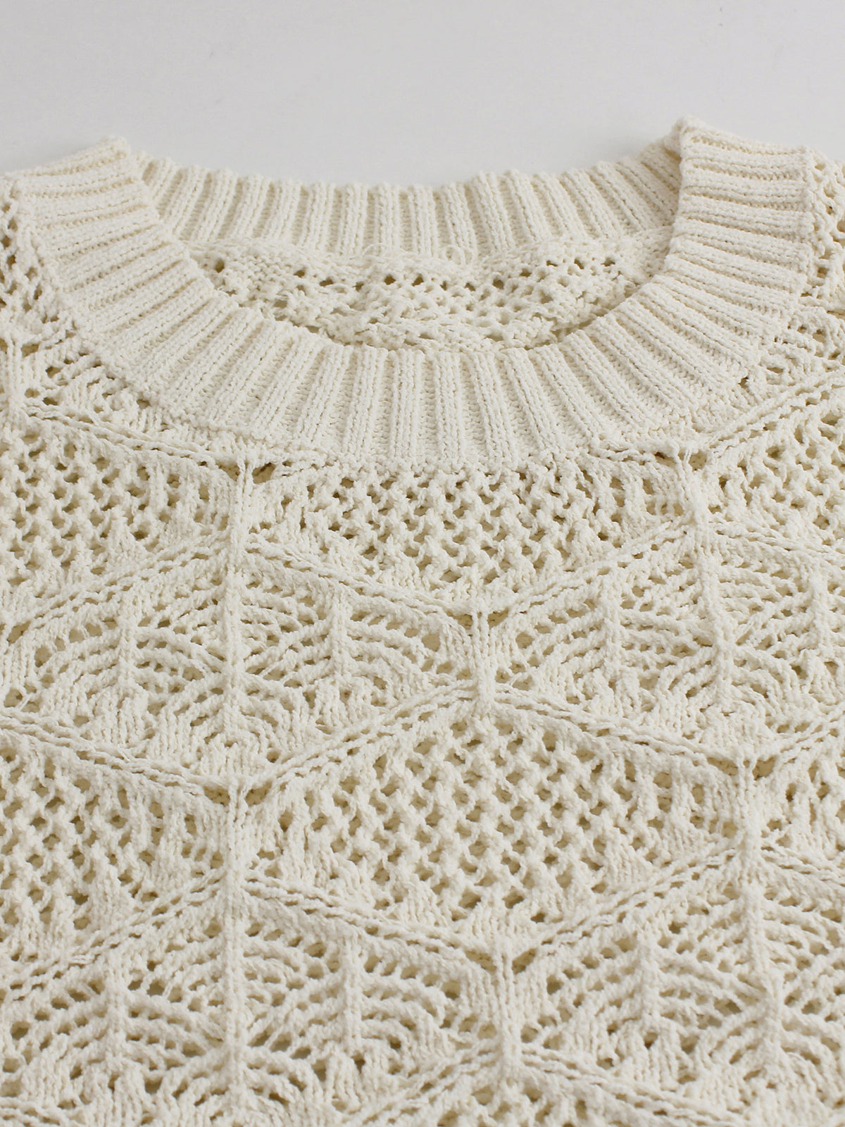 Off-white cropped sweater neckline with scalloped eyelet lace trim and open pointelle knit texture