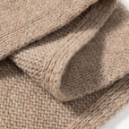 Fuzzy wool triangle scarf fabric close-up, taupe knit texture with ribbed edge