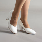 White leather pumps with closed toes, V-cut openings, and block heels