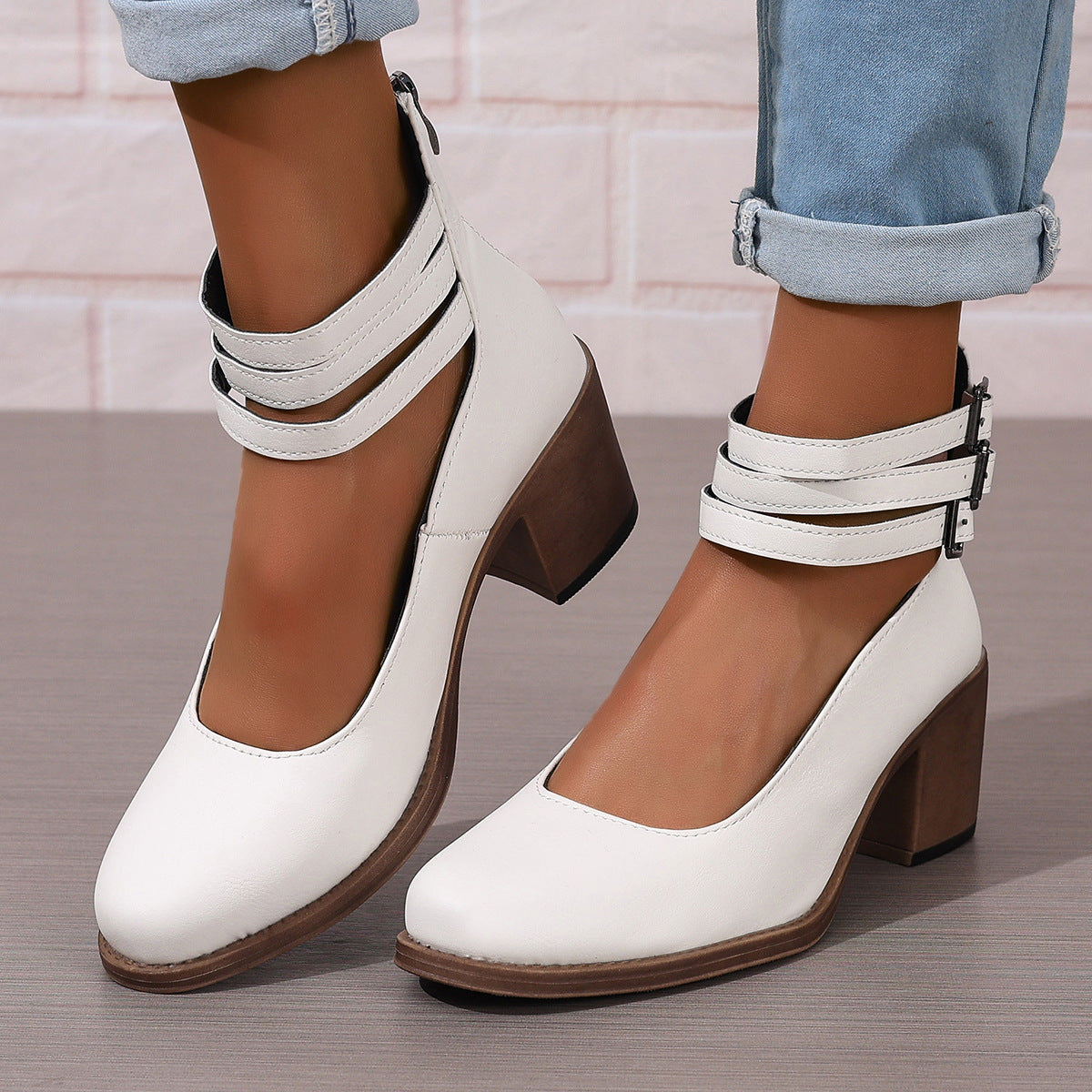 White closed-toe block heel pumps with ankle strap and buckle closure