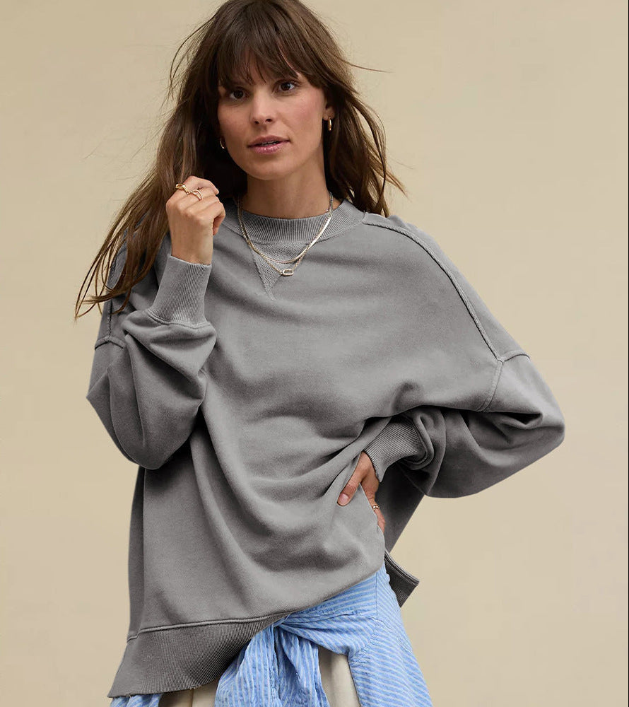 Oversized crewneck sweatshirt in dark gray with exposed seams and side slits at hem