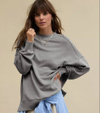 Oversized crewneck sweatshirt in dark gray with exposed seams and side slits at hem