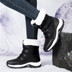 Women’s black faux fur lined lace-up snow boots with lug sole and high cuff.
