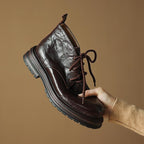 Women’s lace-up ankle boots in dark color, round toe, chunky lug sole, pull tab