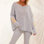 Light gray oversized knit pullover sweater with metallic flower motifs and drop shoulders
