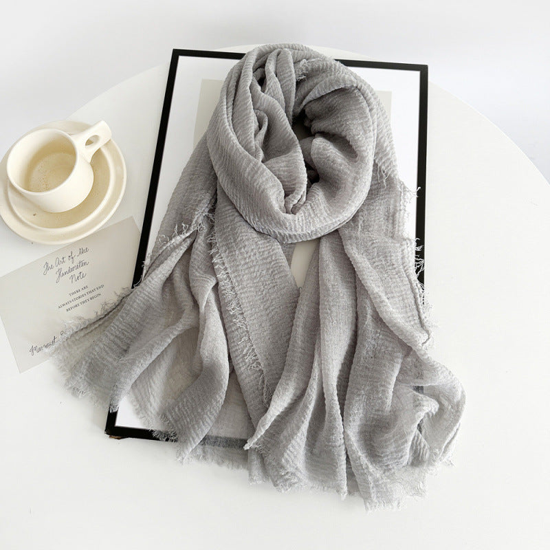 Women’s cotton scarf in light gray, long crinkle gauze with frayed fringe ends