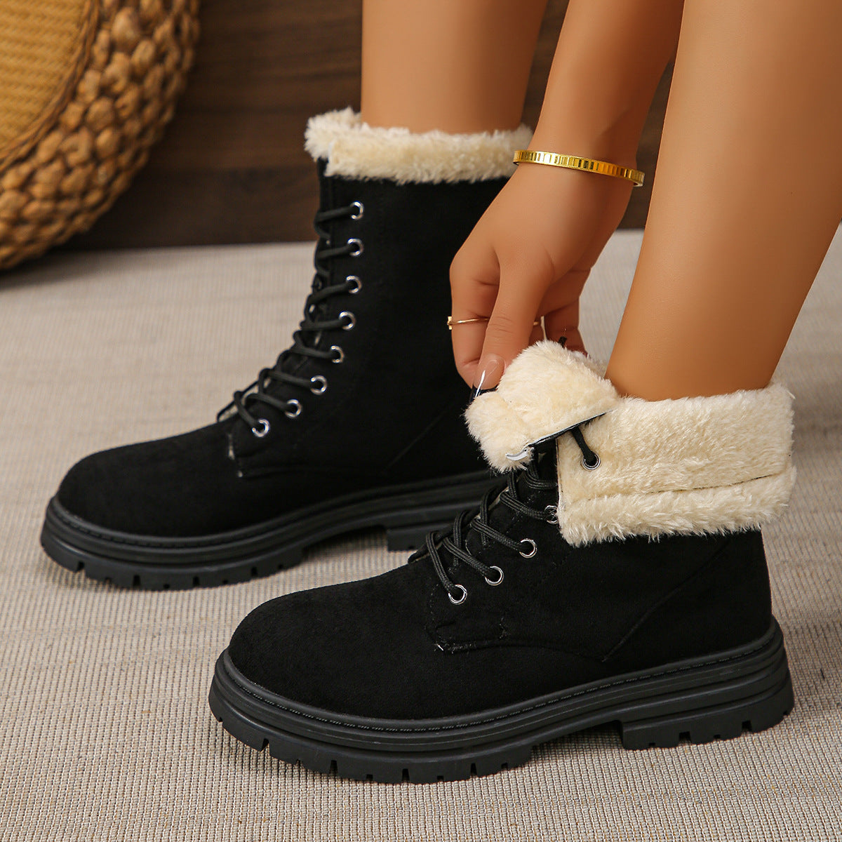 Black faux suede lace-up combat boots with faux fur fold-over cuff and lug sole