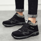 Black snow boots with faux fur lining, hook-and-loop straps, textured lug sole
