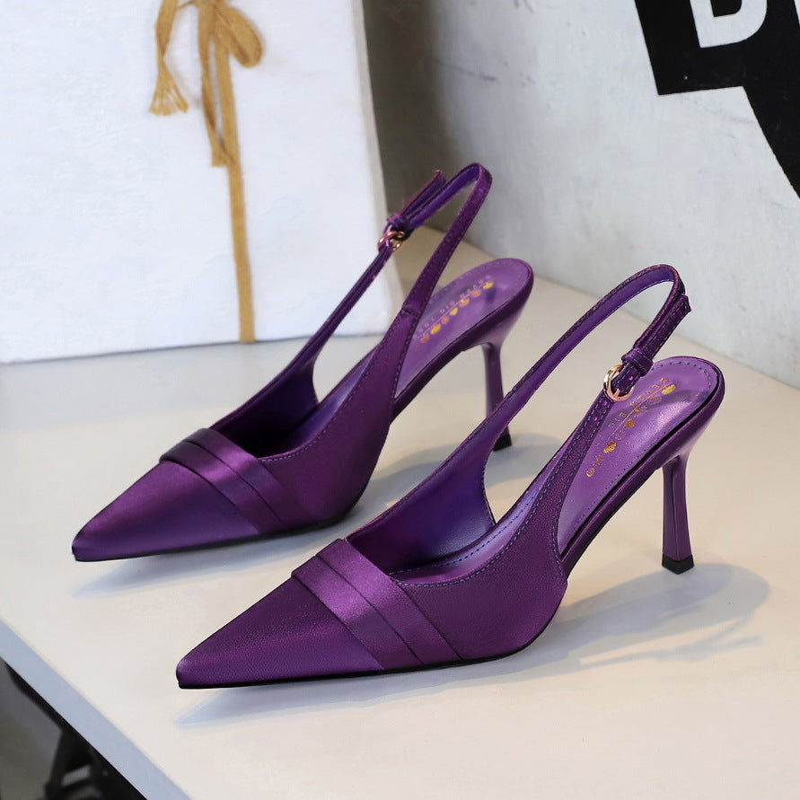 Purple satin slingback heels with pointed toe, stiletto heel, and folded vamp band.