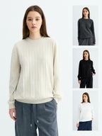 Cream ribbed crew neck sweater with wide knit texture and banded cuffs