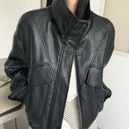Cropped dark faux leather jacket with stand collar and zip front, flap pockets