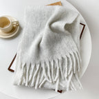 Oversized fuzzy scarf with fringe ends, light gray, neatly folded for display