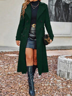 Dark green long wool coat with notch lapels, double-breasted buttons and a tailored waist